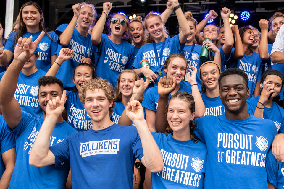 A crowd of SLU students in spirit wear cheer together