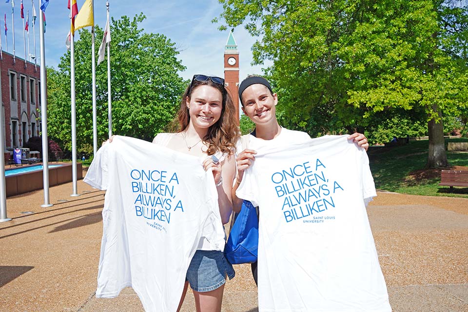 Senior T-shirt Two students pose for a photo outside on campus holding up t-shirts that sayonce a Billiken always a Billiken.