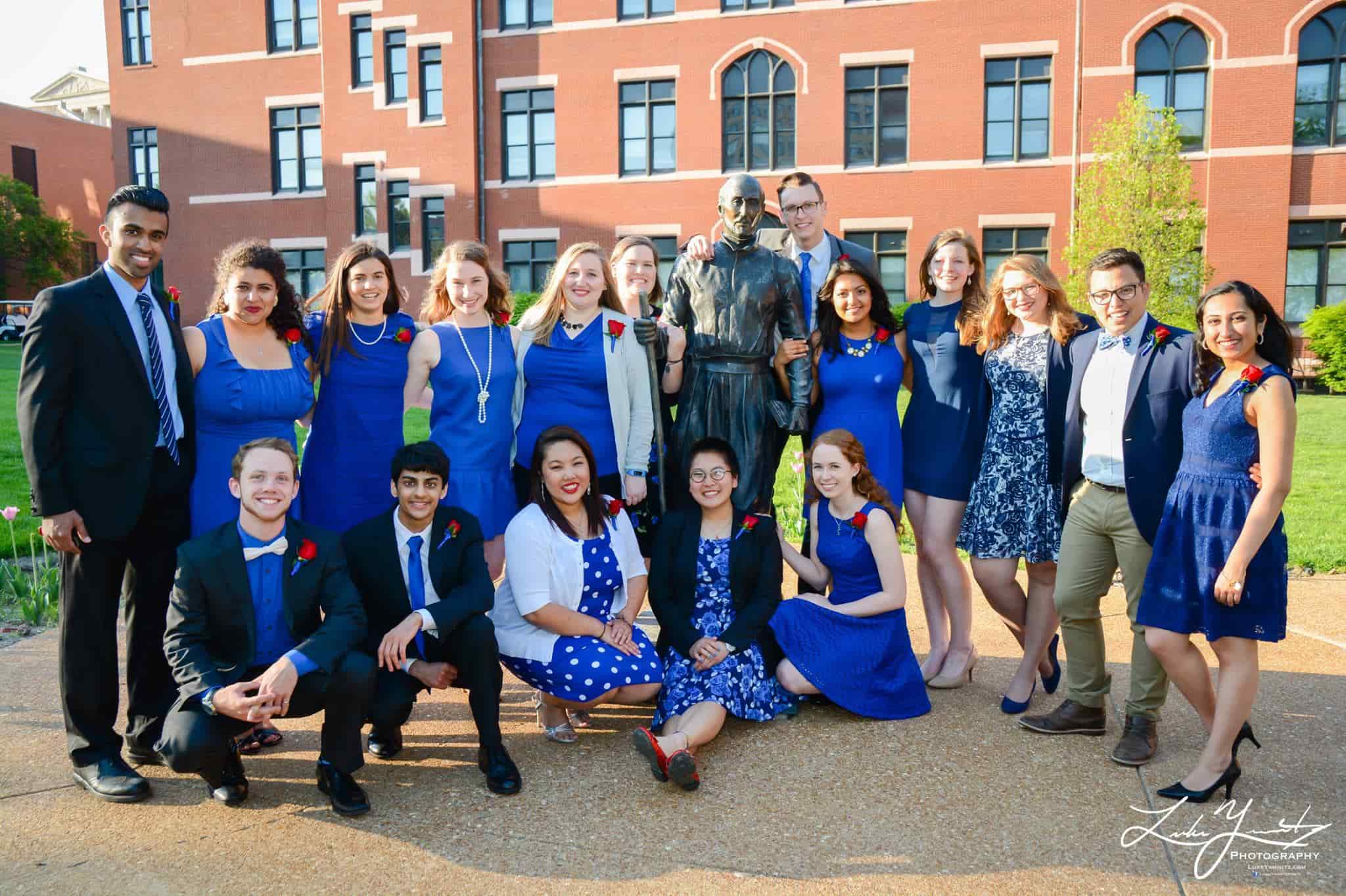 Spirit of the Billiken 2016 winners pose for a photo outside with a statue of St. Thomas Aquinas