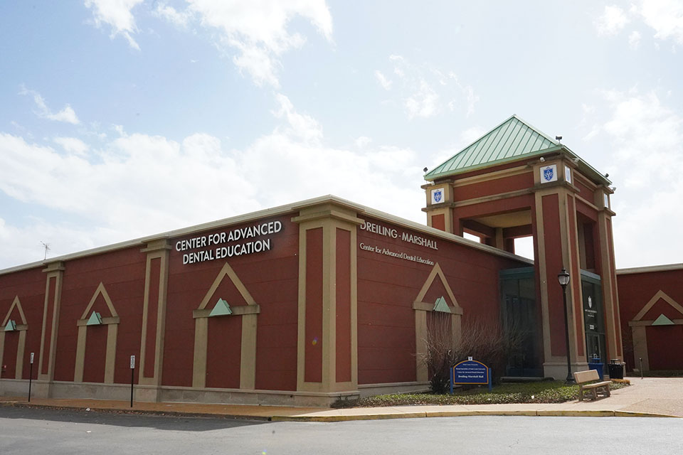 A brick building says Center for Advanced Dental Education on the side.