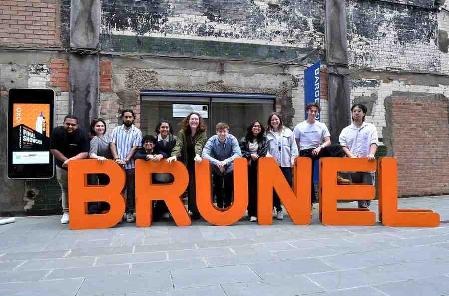 Image of students standing in front of a sign that spells out Brunel.
