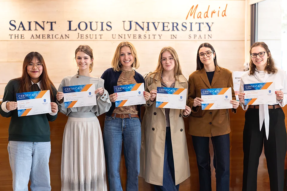 SLU-Madrid's Department of Science and Engineering Celebrates Women in Science Six women hold certificates and smile for photo with the SLU-Madrid logo in the background.