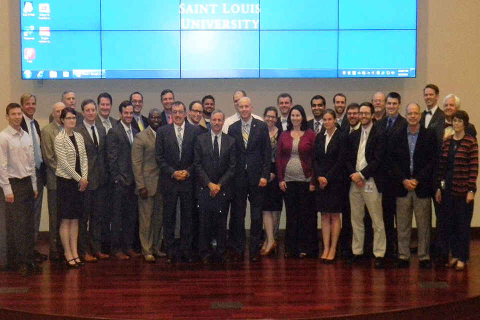 Participants of the lecture series standing together on stage