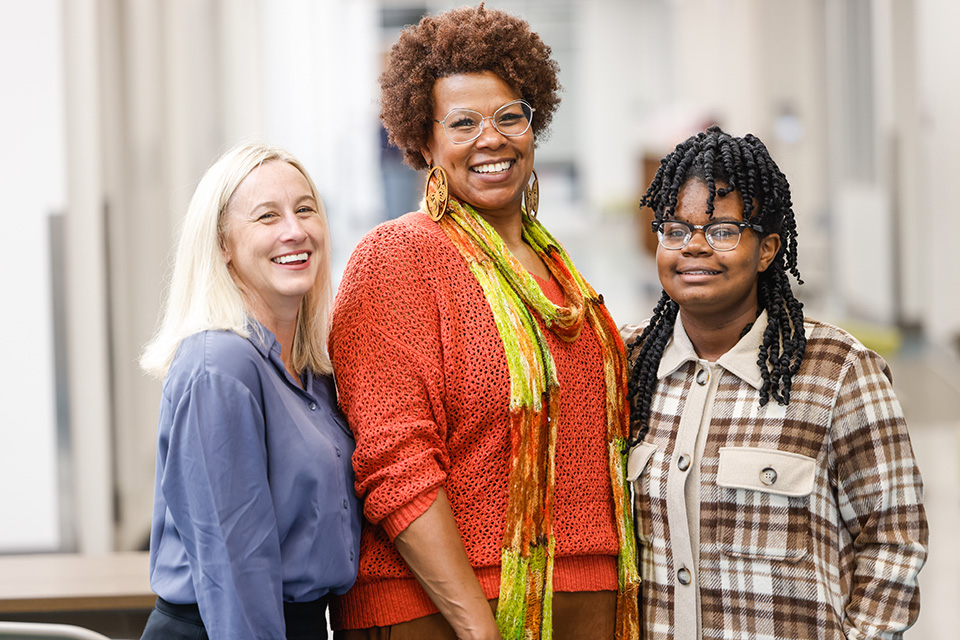 SLU Speech-Language Pathologist Christine Rose, left, with Jamie Saunders-Anglin, center, and her daughter Octavia at City Garden Montessori on Nov. 3, 2022. Photo by Sarah Conroy.