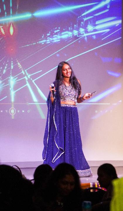 Srija Boddu sings on stage at the ICCA competition Srija Boddu sings on stage at the ICCA competition