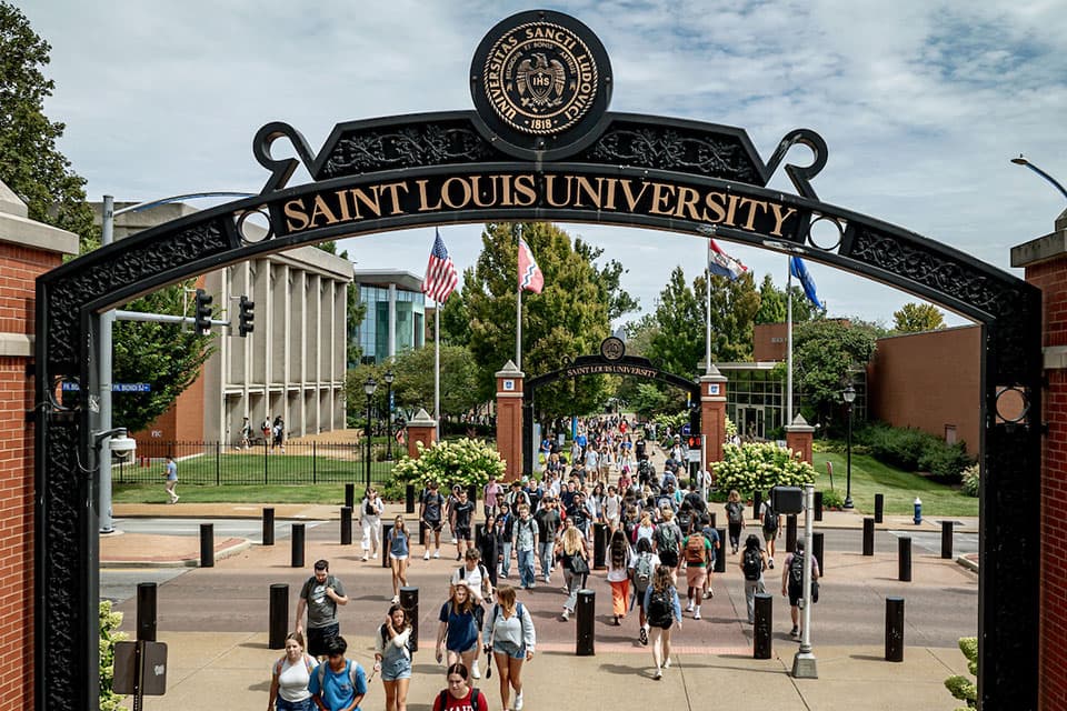 Students walk through the SLU pedestrian gates at Grand Boulevard.