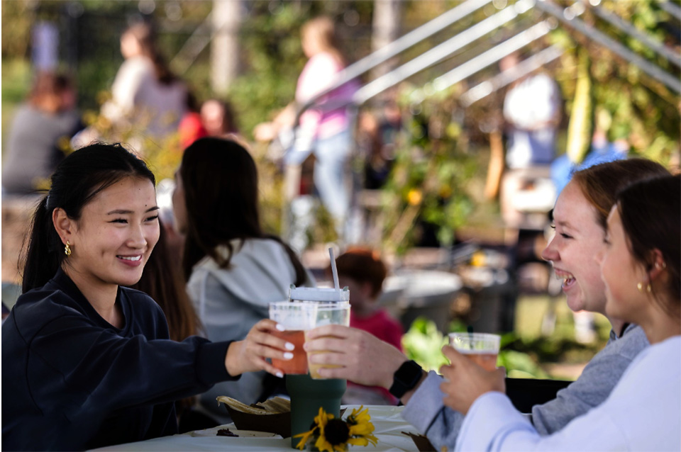 Two people enjoying a beverage at a SLU event.