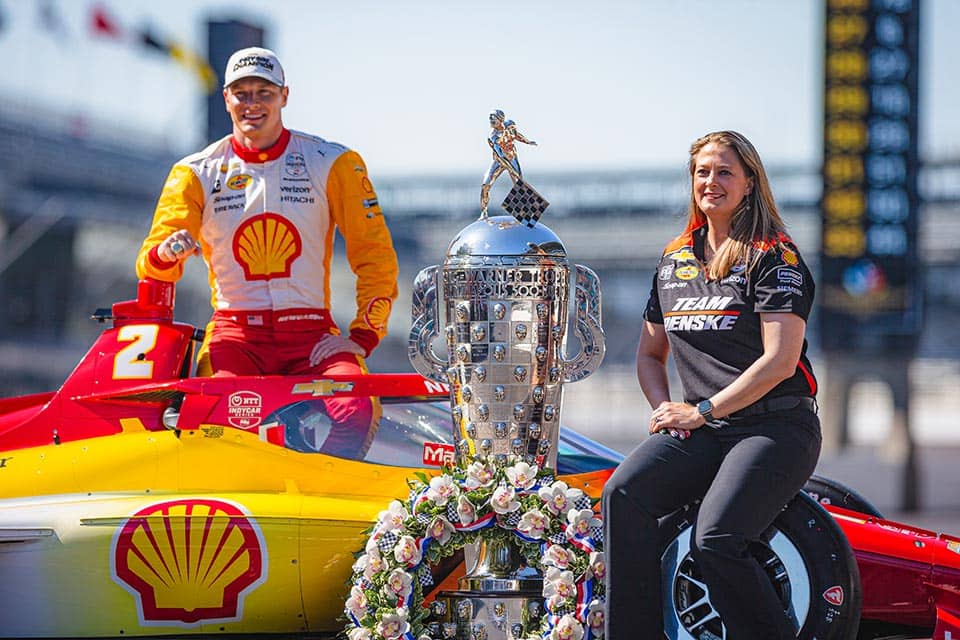 Lauren Sullivan poses with the winning car and trophy from the Indy 500